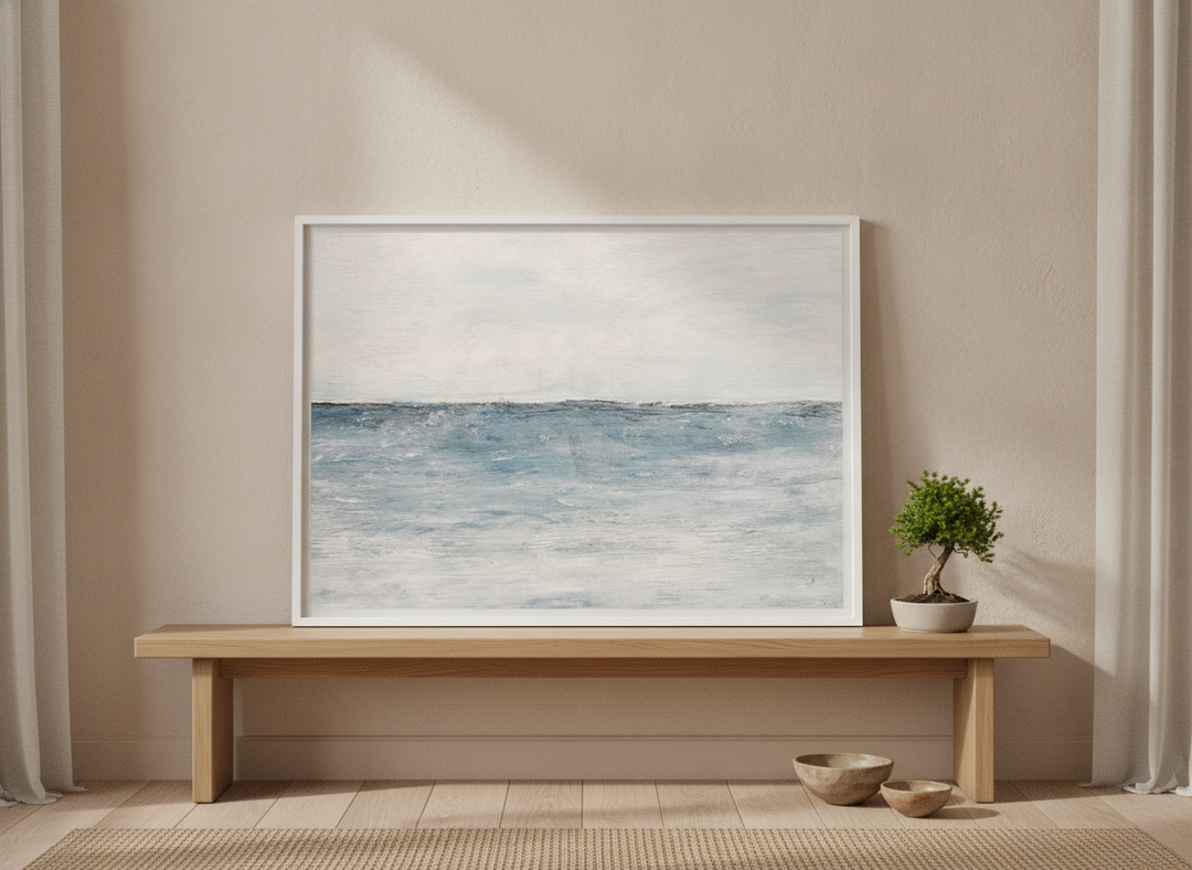 Modern wall art print standing on a bench in a warm Japandi bedroom