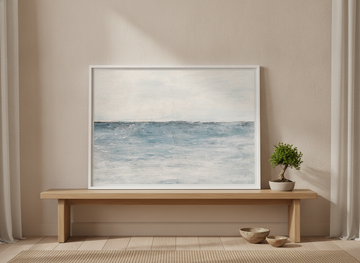 Modern wall art print standing on a bench in a warm Japandi bedroom