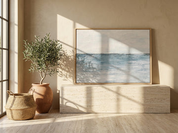 Modern wall art print standing on a console in a Mediterranean bathroom