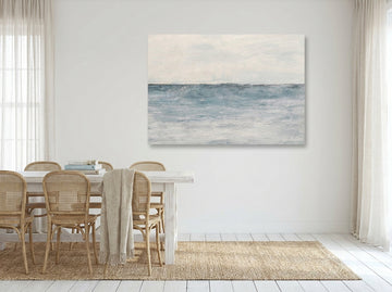 Stretched canvas wall art styled on the wall in a coastal dining room