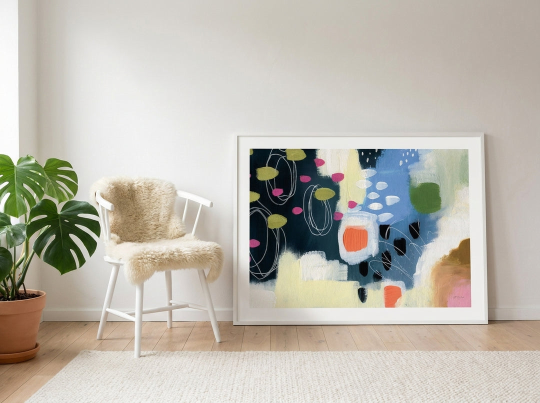 Modern wall art print leaning against the wall in a bright Scandinavian bedroom