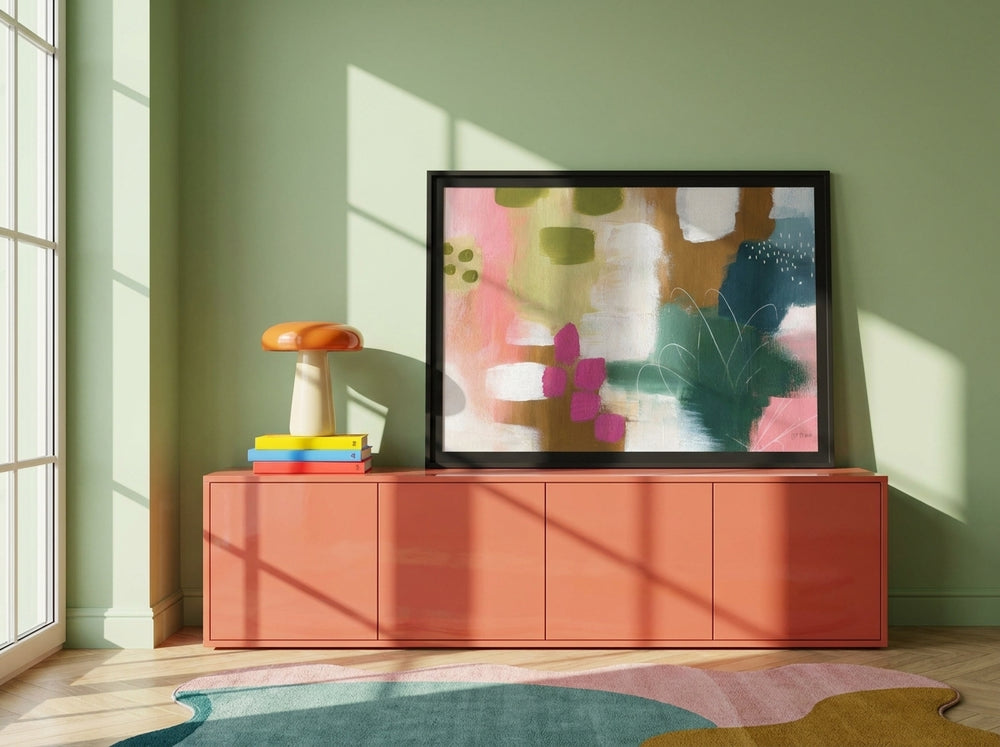 Modern wall art print standing on a sideboard in a colourful eclectic bedroom