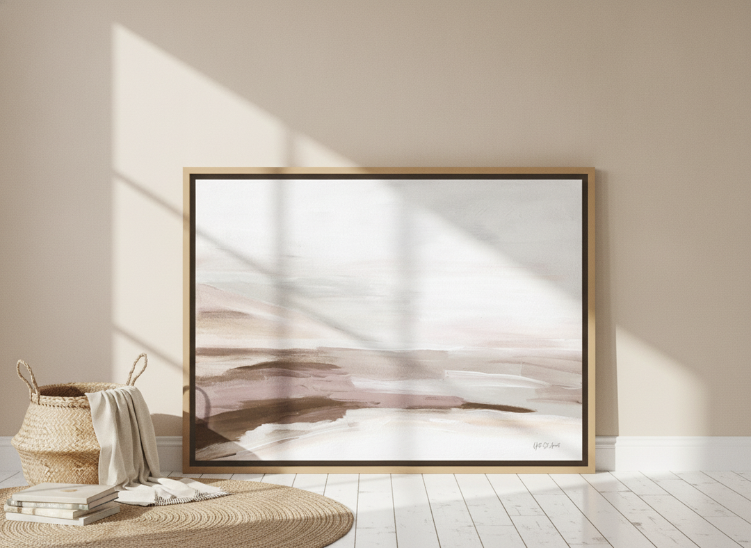 Oversized statement canvas wall art with a natural timber surround leaning against the wall in a coastal bedroom