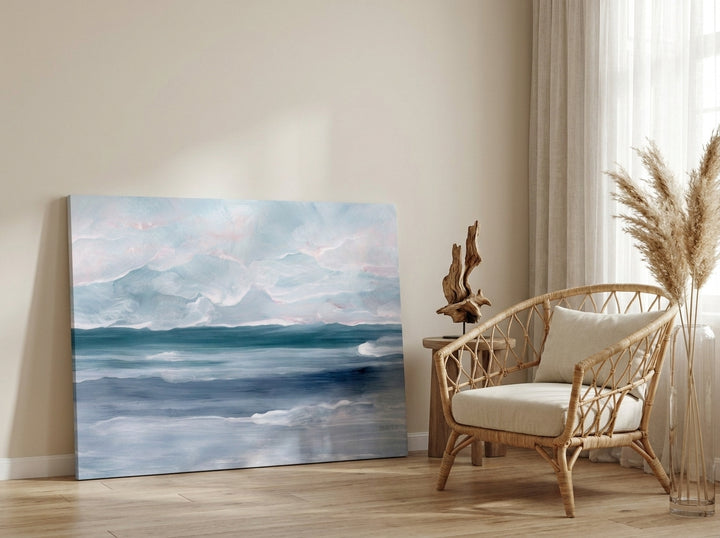 Stretched canvas wall art leaning against the wall in a coastal bedroom