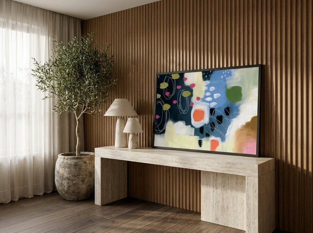 Modern wall art print standing on a console in a luxe dining room