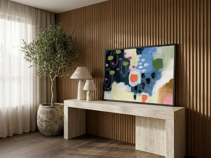 Modern wall art print standing on a console in a luxe dining room
