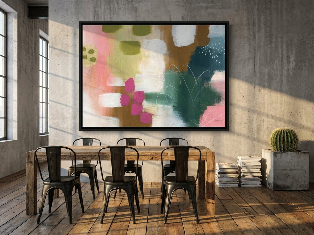 Oversized statement canvas wall art with a black surround styled on the wall in an industrial loft dining room