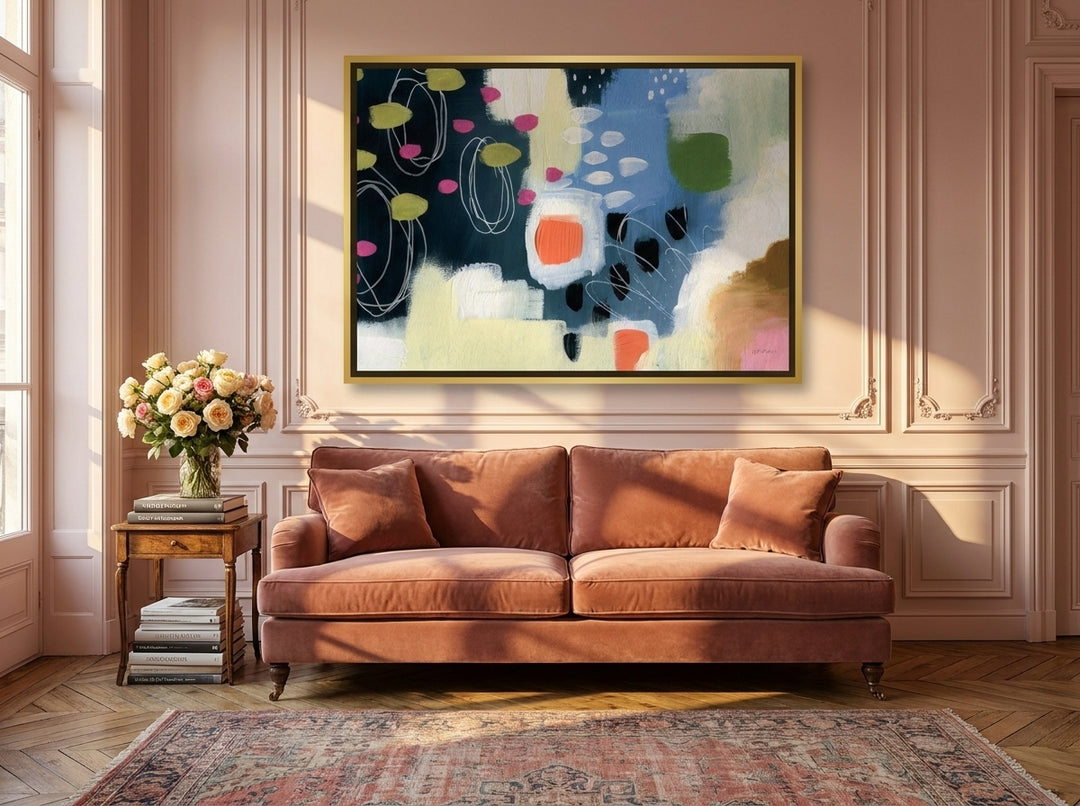 Oversized statement canvas wall art with a gold leaf surround styled on the wall in a Parisian living room