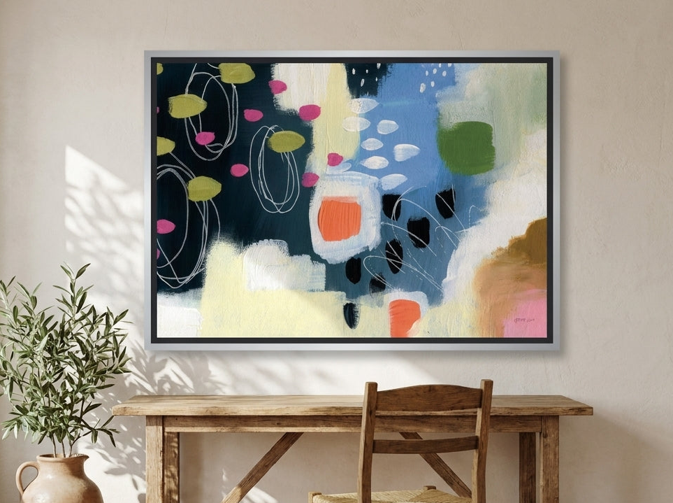 Canvas wall art with a silver leaf surround styled on the wall in a Mediterranean home office