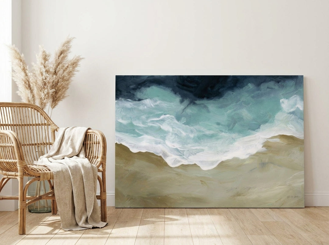 Stretched canvas wall art leaning against the wall in a coastal dining room