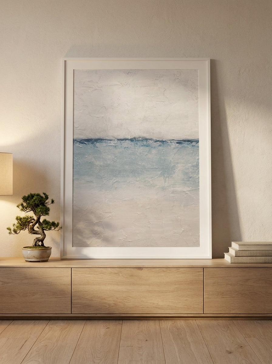 Modern wall art print standing on a sideboard in a warm Japandi bedroom