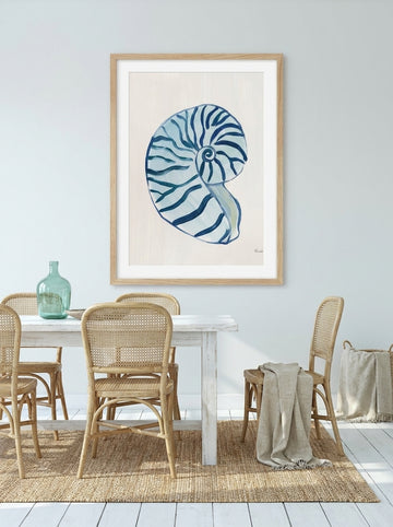 Modern wall art print styled on the wall in a coastal dining room