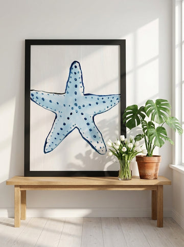 Modern wall art print standing on a bench in a bright Scandinavian bathroom