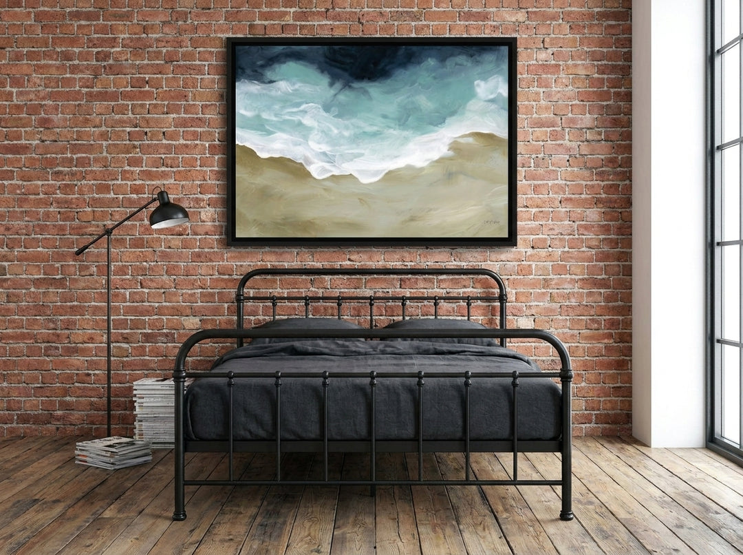 Canvas wall art with a black surround styled on the wall in an industrial loft bedroom