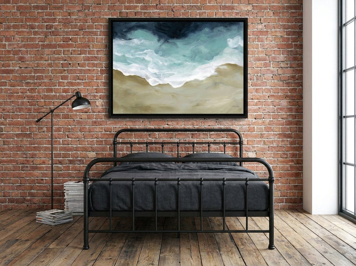 Canvas wall art with a black surround styled on the wall in an industrial loft bedroom