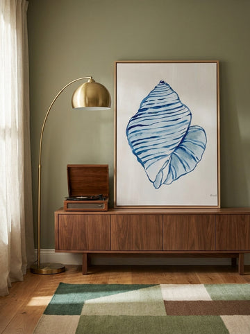Canvas wall art with a natural timber surround standing on a sideboard in a mid-century bedroom