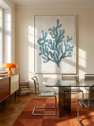 Oversized statement canvas wall art with a white surround styled on the wall in a retro 70s dining room