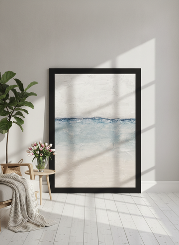 Oversized statement modern wall art print leaning against the wall in a bright Scandinavian living room
