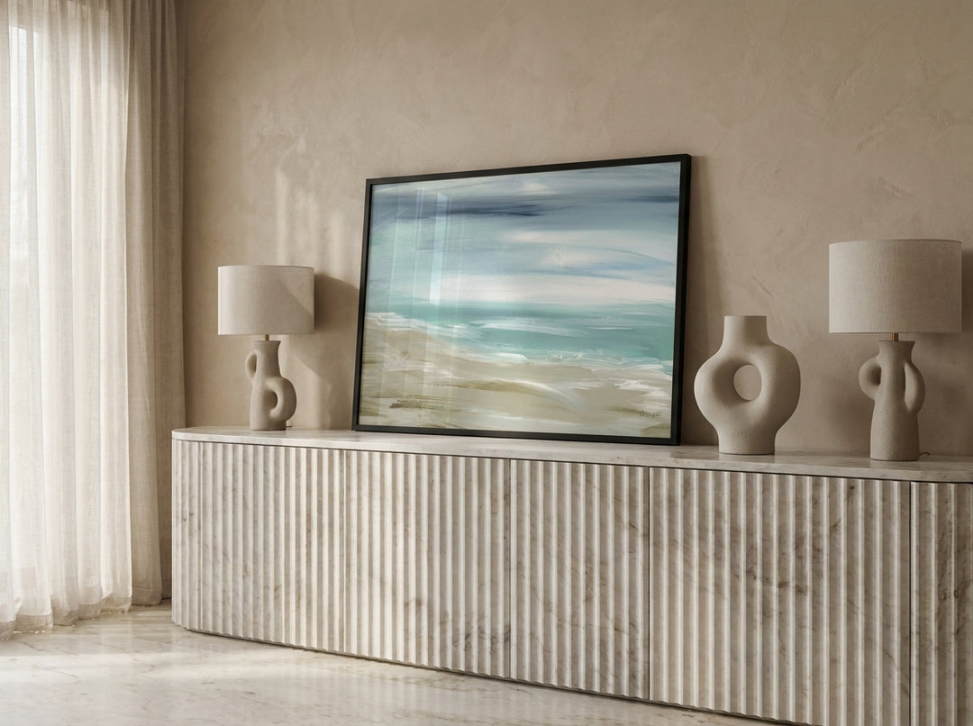Modern wall art print standing on a sideboard in a luxe home office