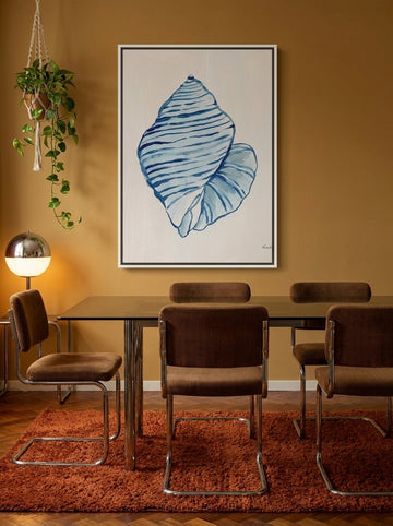 Canvas wall art with a white surround styled on the wall in a retro 70s dining room