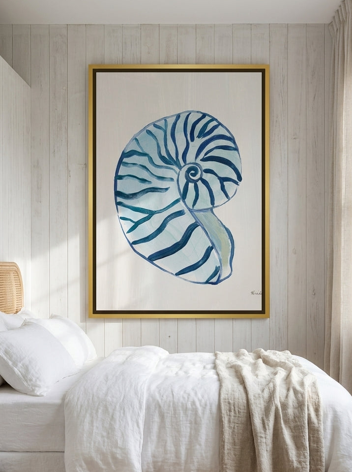 Oversized statement canvas wall art with a gold leaf surround styled on the wall in a coastal bedroom