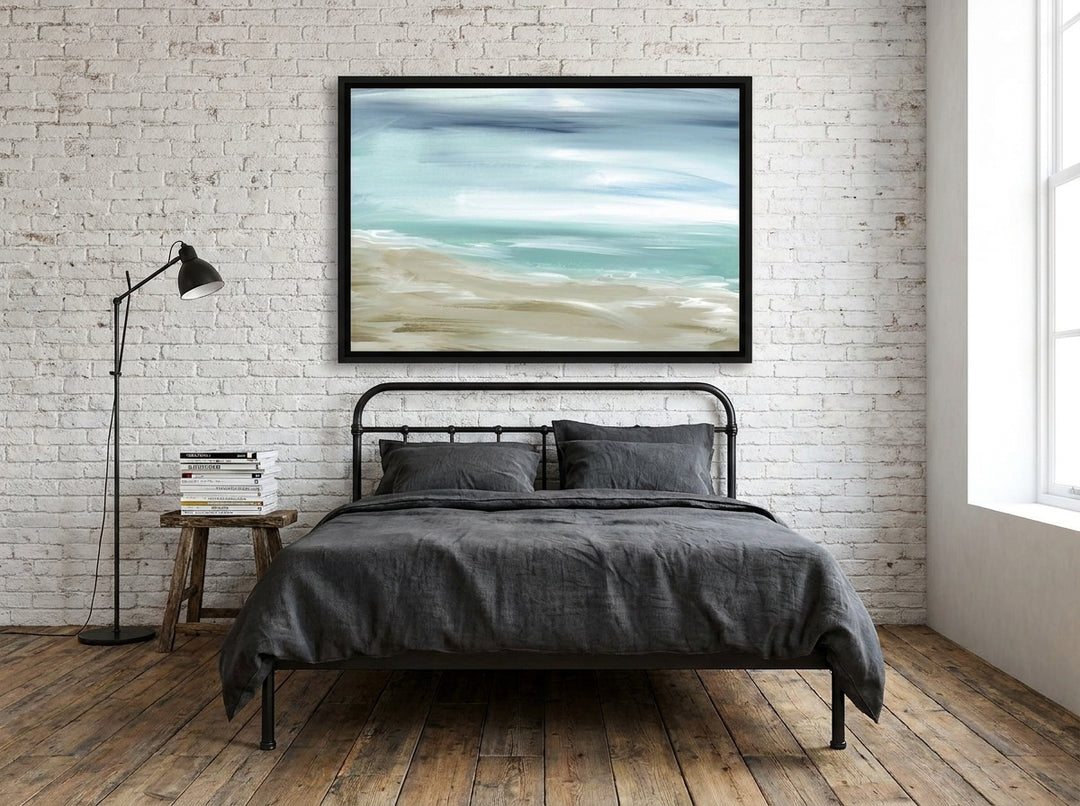 Canvas wall art with a black surround styled on the wall in an industrial loft bedroom