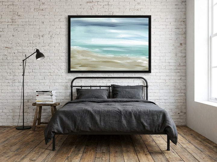 Canvas wall art with a black surround styled on the wall in an industrial loft bedroom