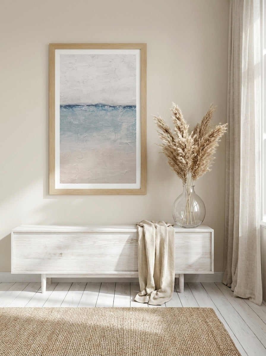 Modern wall art print styled on the wall in a coastal living room