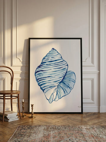 Oversized statement canvas wall art with a black surround leaning against the wall in a Parisian living room