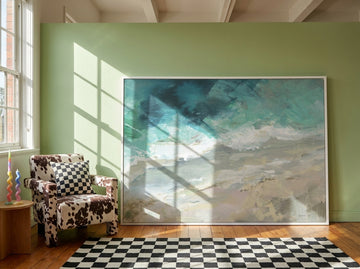 Oversized statement modern wall art print leaning against the wall in a colourful eclectic dining room
