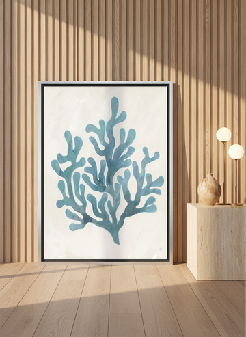 Canvas wall art with a silver leaf surround leaning against the wall in a luxe bathroom