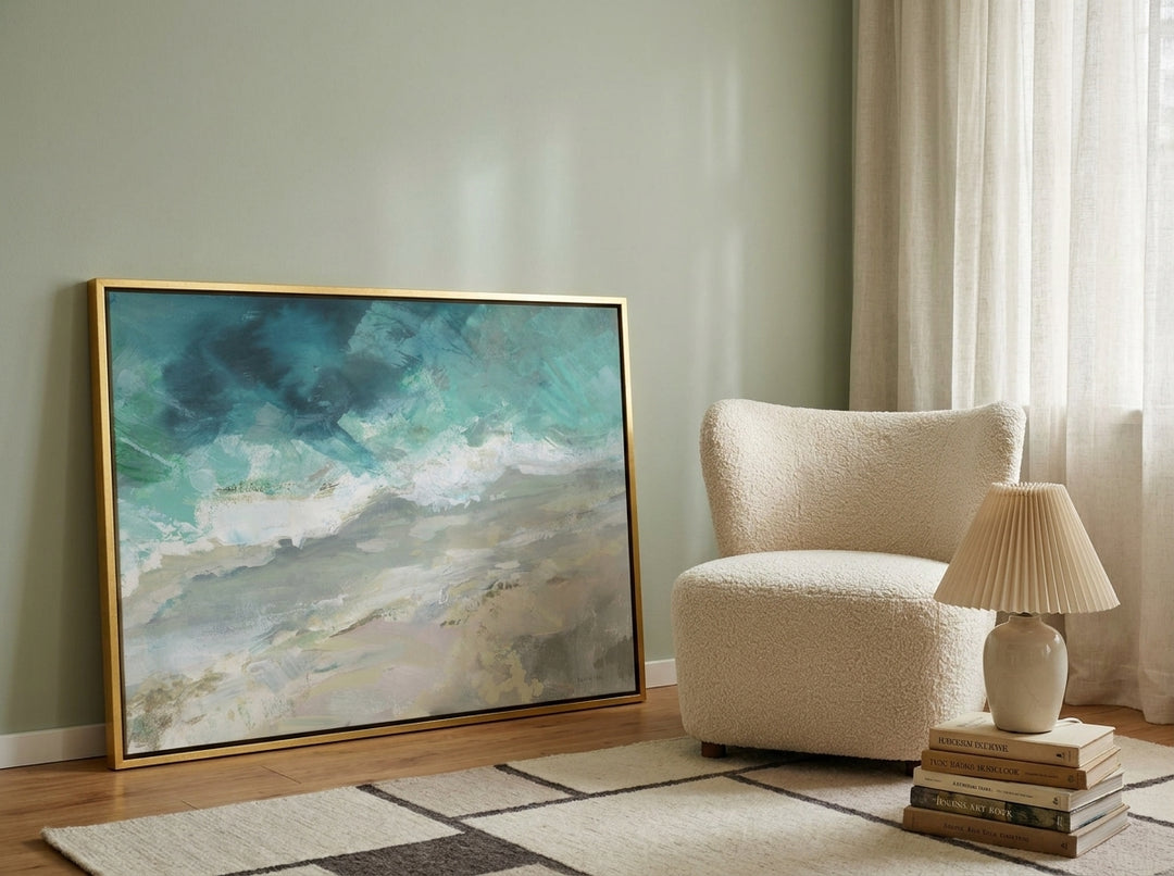 Canvas wall art with a gold leaf surround leaning against the wall in a mid-century home office