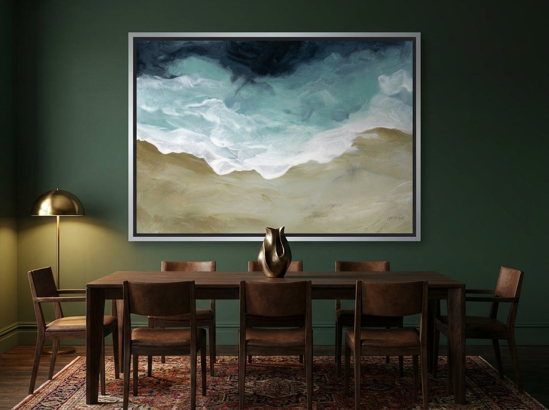 Oversized statement canvas wall art with a silver leaf surround styled on the wall in a moody dining room