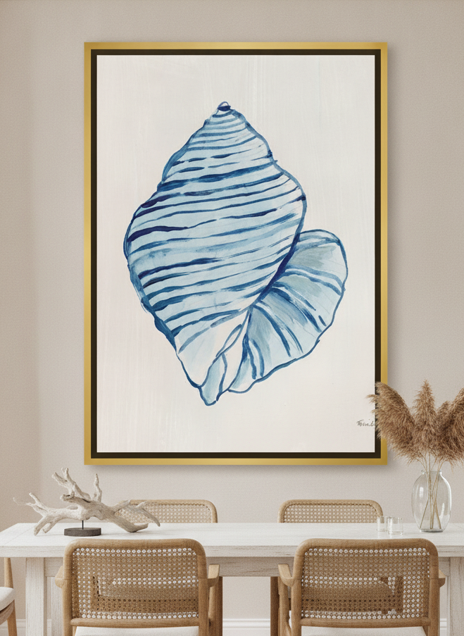 Oversized statement canvas wall art with a gold leaf surround styled on the wall in a coastal dining room