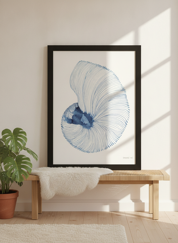 Modern wall art print standing on a bench in a bright Scandinavian bedroom