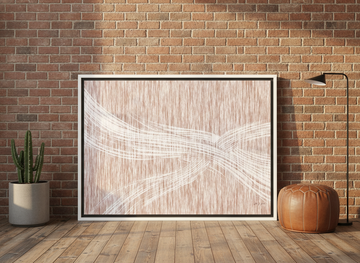 Canvas wall art with a white surround leaning against the wall in an industrial loft bedroom