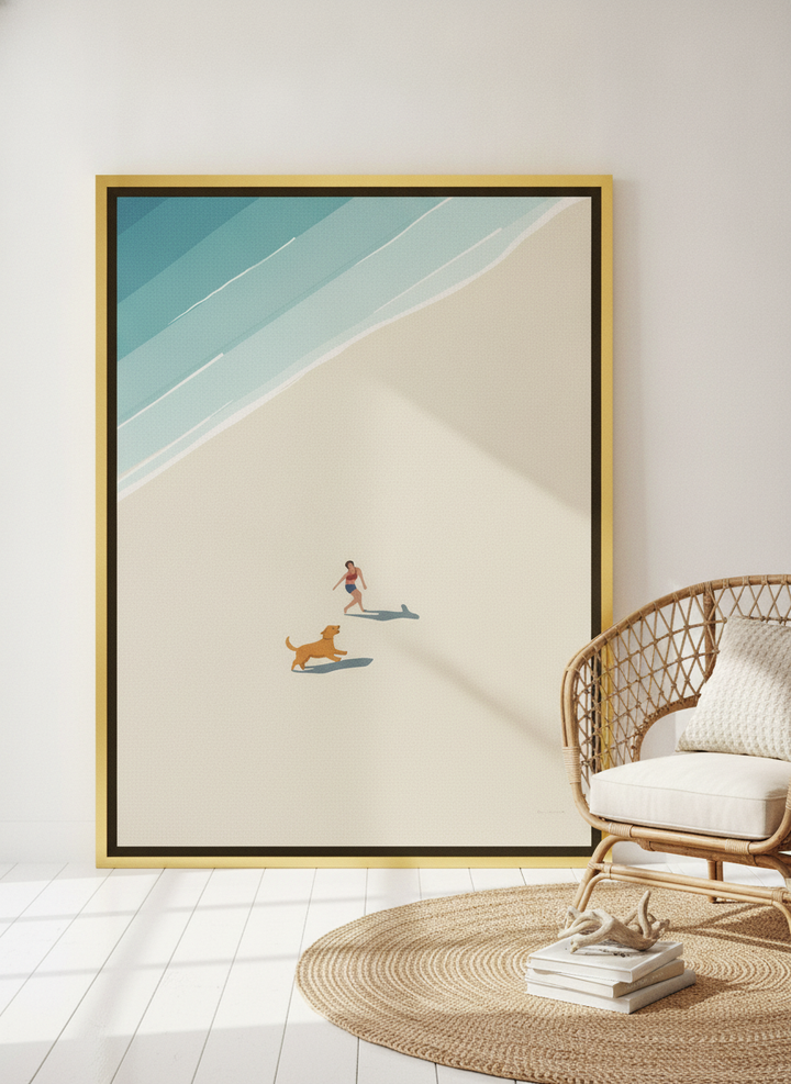 Oversized statement canvas wall art with a gold leaf surround leaning against the wall in a coastal living room