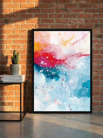 Canvas wall art with a black surround leaning against the wall in an industrial loft home office