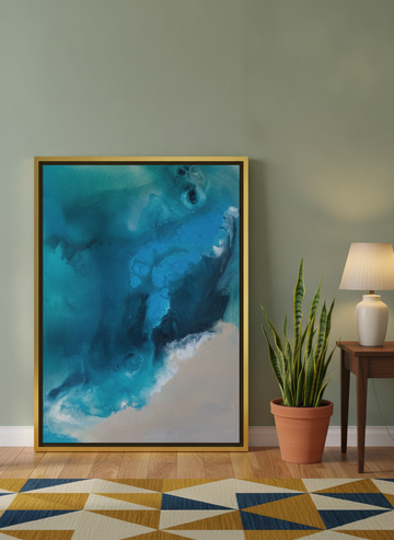 Canvas wall art with a gold leaf surround leaning against the wall in a mid-century home office