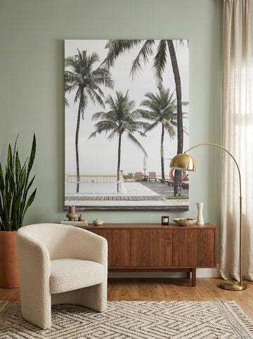 Stretched canvas wall art styled on the wall in a mid-century living room