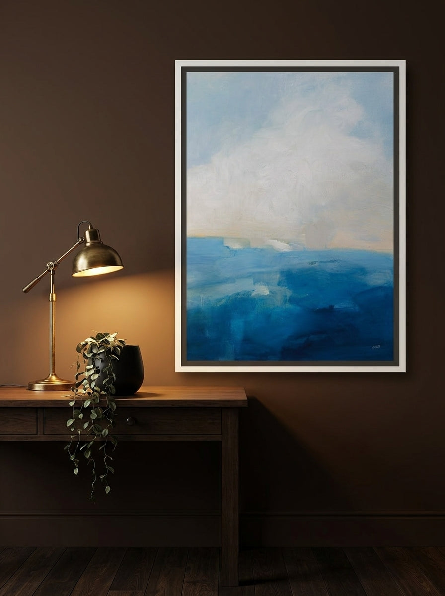 Canvas wall art with a white surround styled on the wall in a moody home office