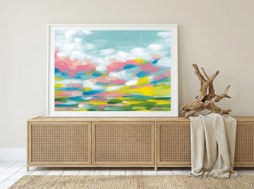 Modern wall art print standing on a sideboard in a coastal bedroom