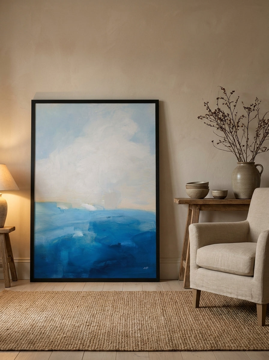 Oversized statement modern wall art print leaning against the wall in a warm Japandi living room