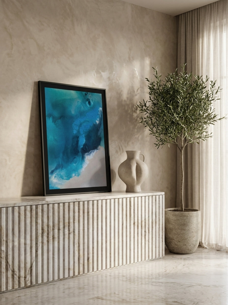 Modern wall art print standing on a sideboard in a luxe home office