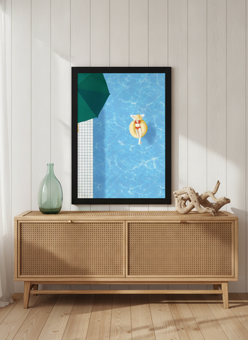 Modern wall art print standing on a sideboard in a coastal bathroom