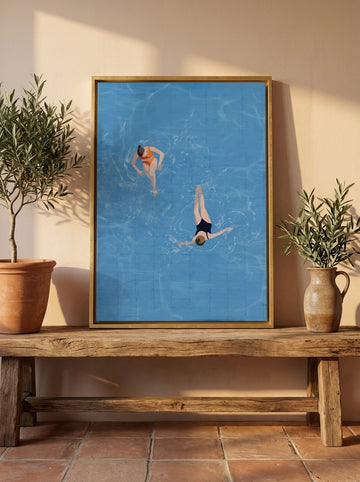 Canvas wall art with a gold leaf surround standing on a bench in a Mediterranean bathroom