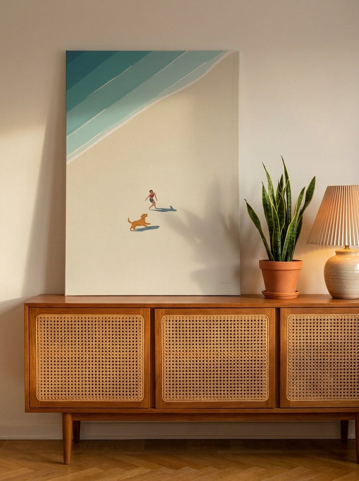 Stretched canvas wall art standing on a sideboard in a mid-century living room