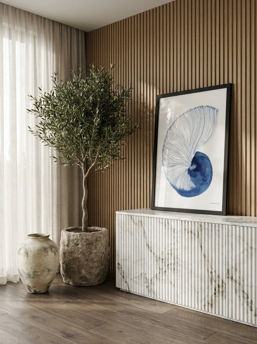 Modern wall art print standing on a sideboard in a luxe home office