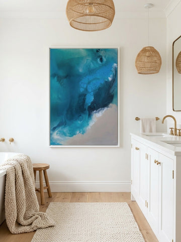Canvas wall art with a white surround styled on the wall in a bright Scandinavian bathroom