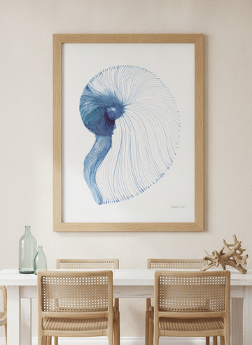 Modern wall art print styled on the wall in a coastal dining room